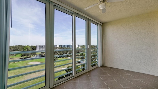 unfurnished sunroom with ceiling fan and a wealth of natural light