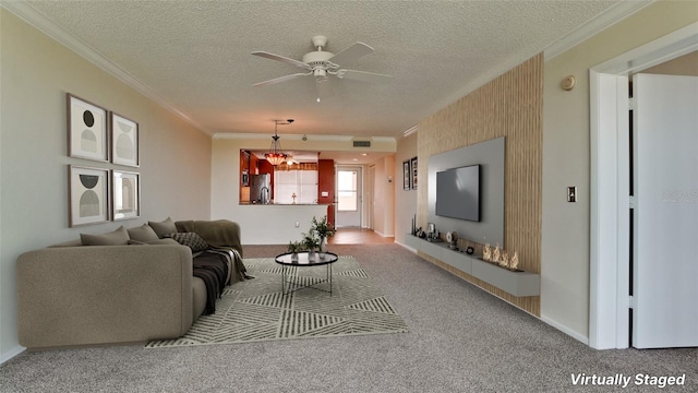 living room with ornamental molding, carpet, ceiling fan, and a textured ceiling