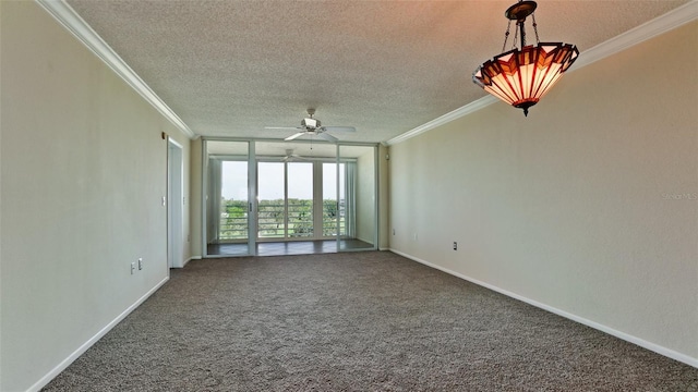 carpeted spare room featuring ornamental molding, ceiling fan, and a textured ceiling