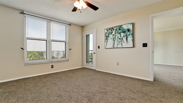 carpeted empty room with ceiling fan and a textured ceiling