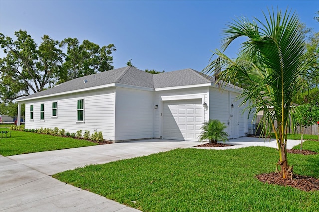 view of side of home with a yard and a garage