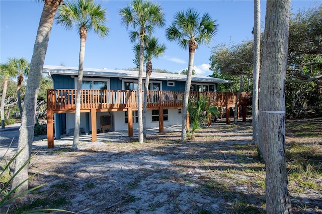 back of property with a wooden deck