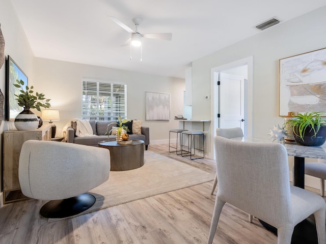 living room with ceiling fan and light hardwood / wood-style floors