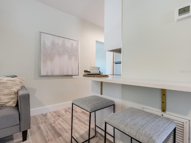 home office with light hardwood / wood-style flooring