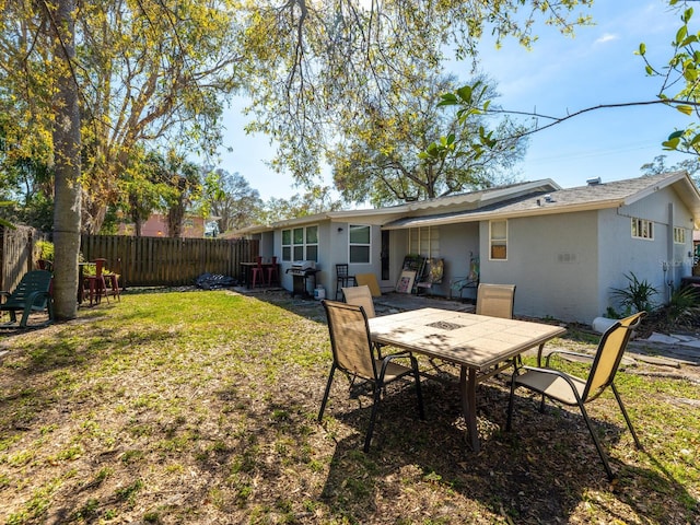 rear view of house featuring a yard