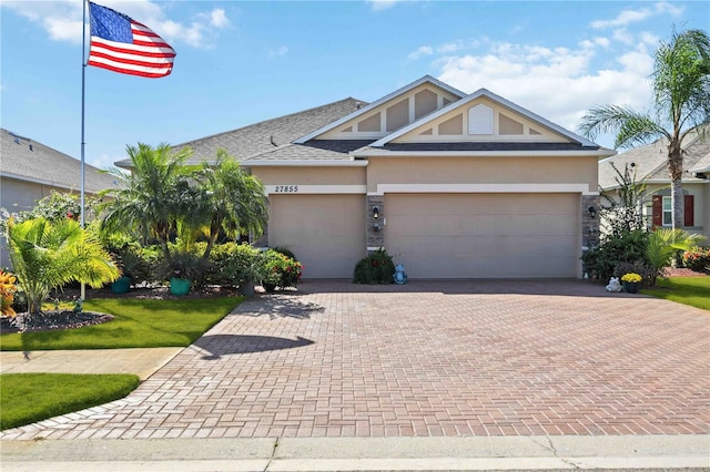 view of front of home featuring a front yard and a garage