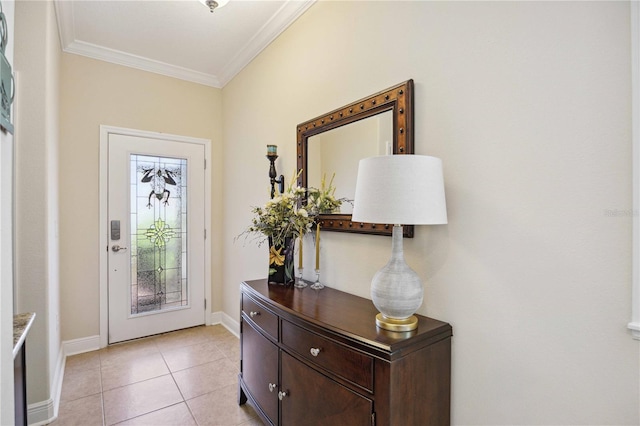 tiled entrance foyer featuring ornamental molding