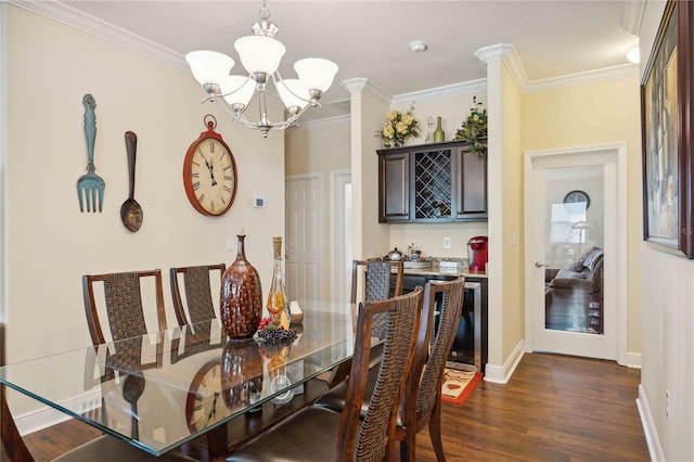 dining area with ornamental molding, dark wood-type flooring, and an inviting chandelier