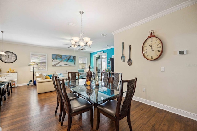 dining room with a wealth of natural light, dark hardwood / wood-style floors, a notable chandelier, and ornamental molding