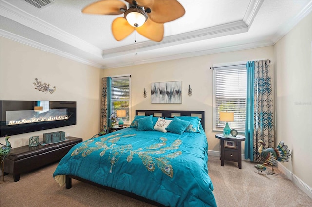 bedroom with crown molding, a raised ceiling, ceiling fan, and carpet floors