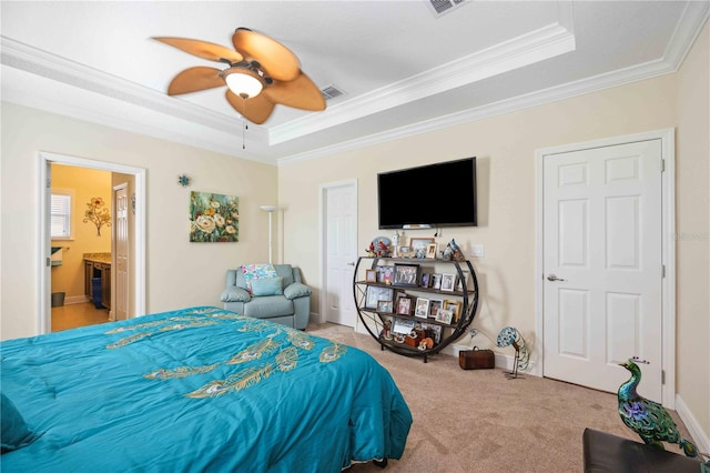 bedroom featuring crown molding, ceiling fan, a tray ceiling, and connected bathroom