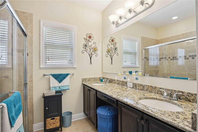 bathroom with tile patterned floors, an enclosed shower, and vanity