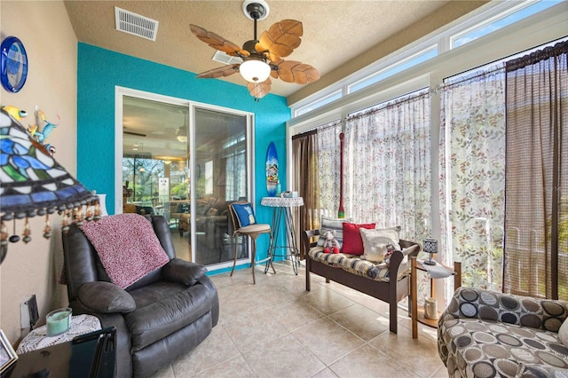 sunroom with ceiling fan and a healthy amount of sunlight