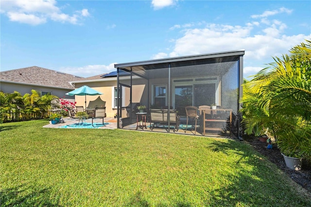 back of property featuring a lawn and a patio