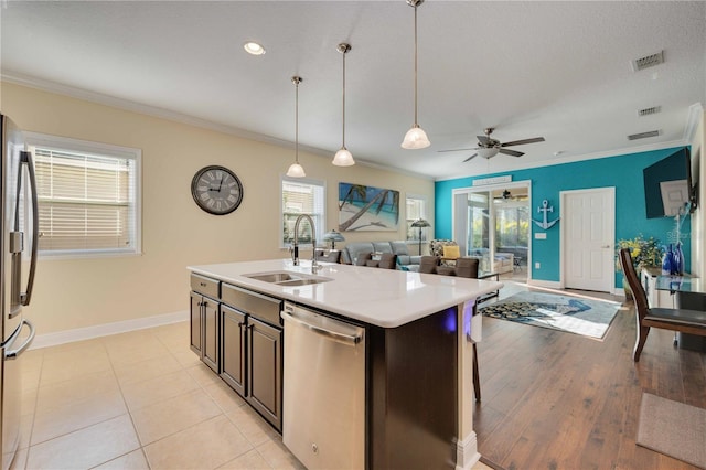 kitchen featuring a kitchen island with sink, light hardwood / wood-style flooring, sink, ceiling fan, and appliances with stainless steel finishes