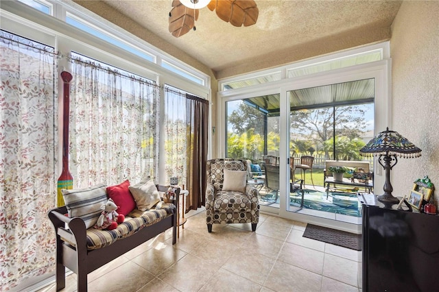 sunroom / solarium featuring ceiling fan