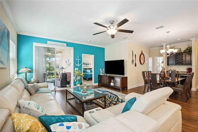 living room with hardwood / wood-style floors, ceiling fan with notable chandelier, a wealth of natural light, and ornamental molding