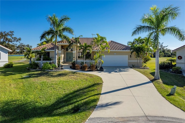 mediterranean / spanish house with a garage and a front yard