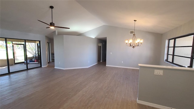 unfurnished room with vaulted ceiling, dark wood-type flooring, and ceiling fan with notable chandelier