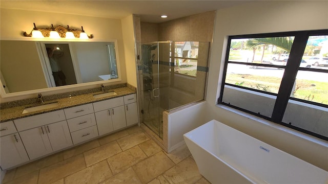 bathroom featuring separate shower and tub and vanity