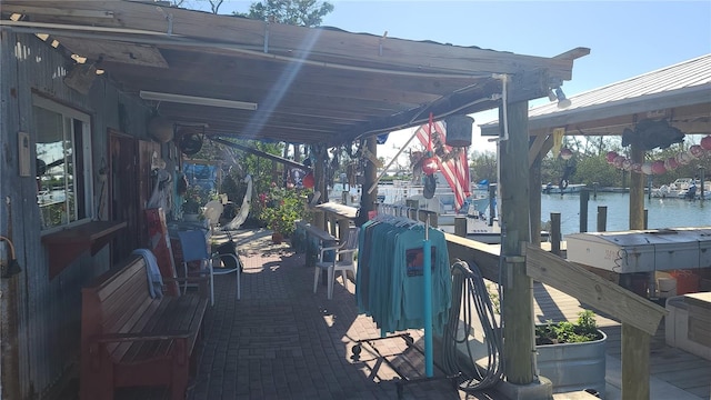 exterior space with a water view and a boat dock