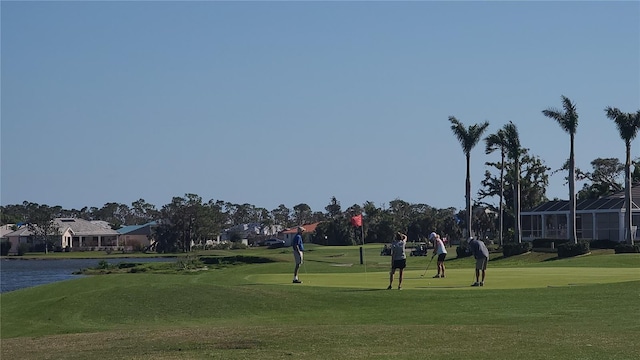 view of community with a lawn and a water view