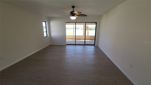 spare room with ceiling fan and dark hardwood / wood-style flooring