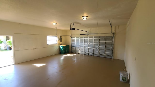 garage with a garage door opener and electric panel