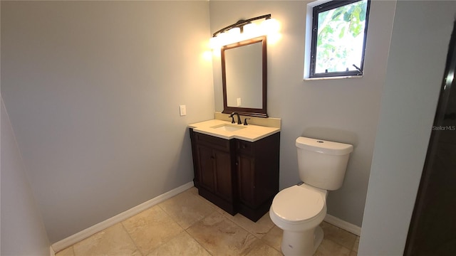 bathroom featuring toilet and vanity