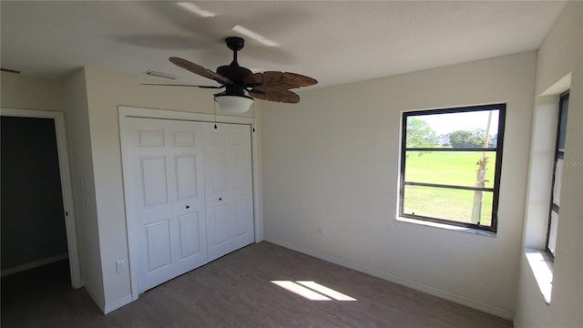 unfurnished bedroom featuring ceiling fan, a closet, and dark hardwood / wood-style floors