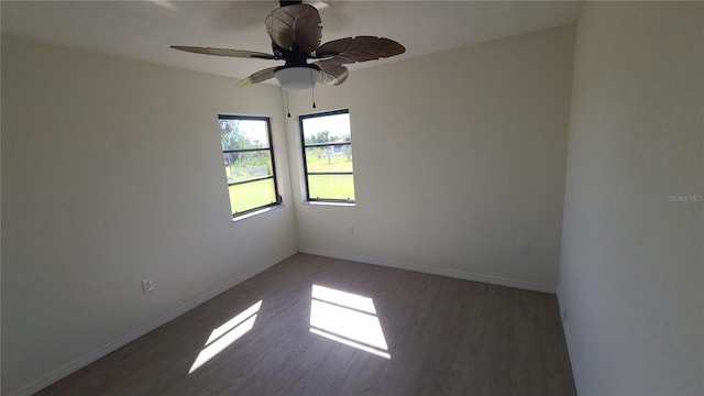 spare room featuring ceiling fan and dark hardwood / wood-style flooring