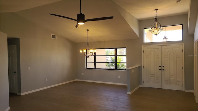 foyer with dark wood-type flooring, ceiling fan with notable chandelier, and high vaulted ceiling