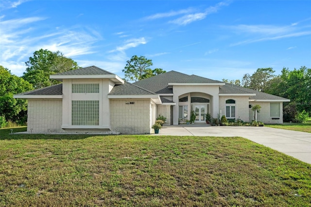 view of front of home with french doors and a front lawn