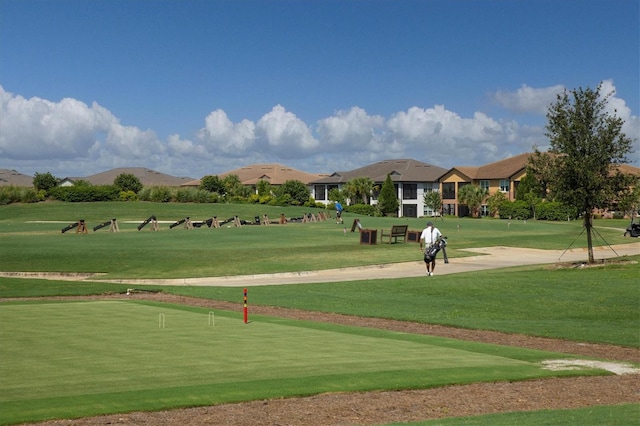 view of property's community with a lawn