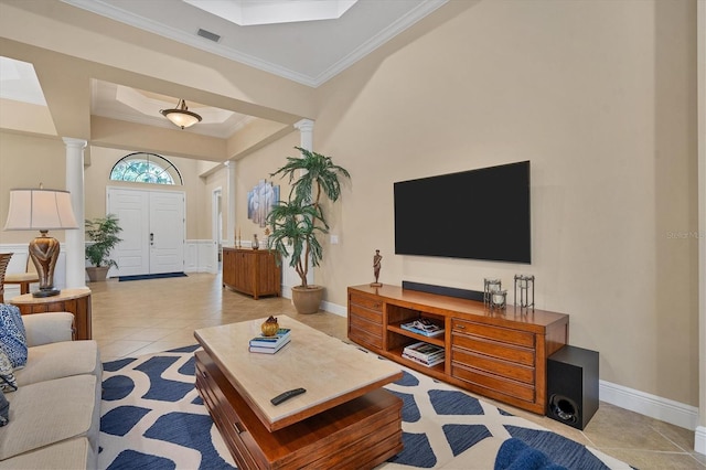 tiled living room featuring crown molding and decorative columns