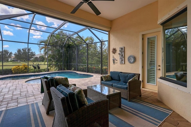 view of swimming pool featuring a patio, ceiling fan, glass enclosure, and an outdoor living space