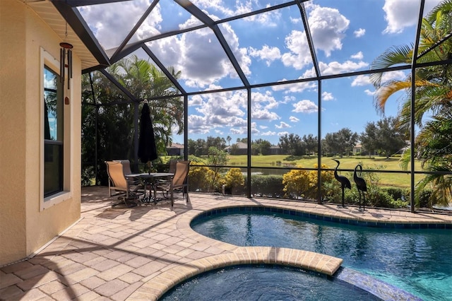 view of pool featuring a patio, a lanai, and an in ground hot tub