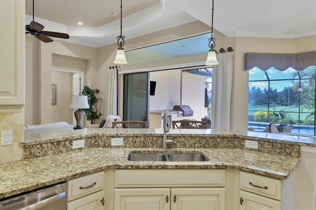 kitchen featuring light stone counters, sink, pendant lighting, and dishwasher