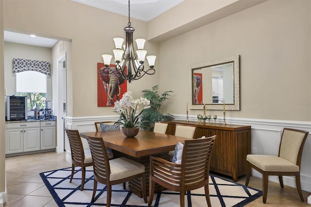 dining room featuring ornamental molding, a notable chandelier, and light tile patterned floors