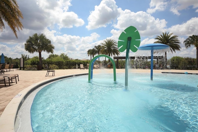 view of swimming pool with pool water feature