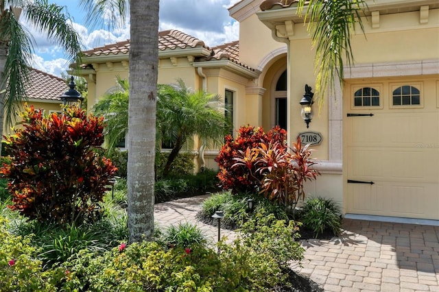 view of exterior entry featuring a garage