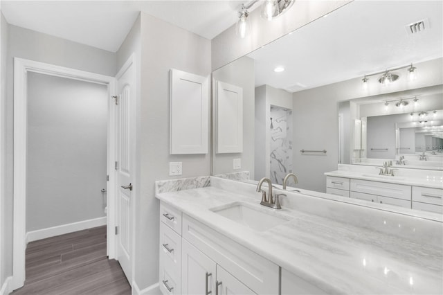 bathroom with oversized vanity and wood-type flooring