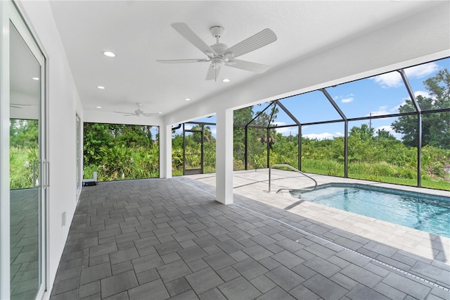 view of pool featuring ceiling fan, a lanai, and a patio area