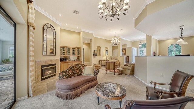 sitting room featuring light colored carpet, crown molding, and a tile fireplace