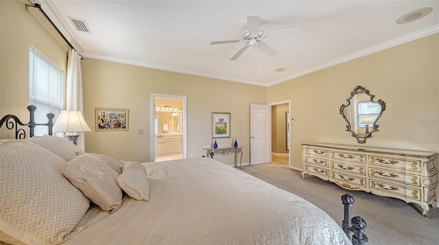 carpeted bedroom featuring a textured ceiling, ensuite bathroom, ceiling fan, and crown molding