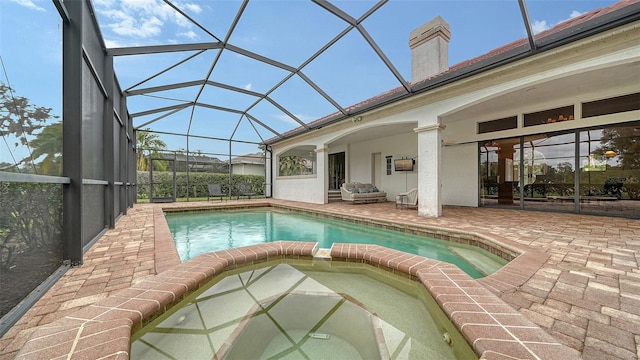 view of pool with a patio and glass enclosure