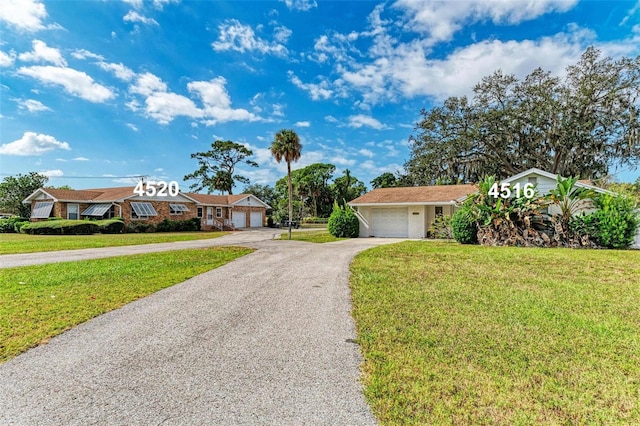 ranch-style home with a front lawn and a garage