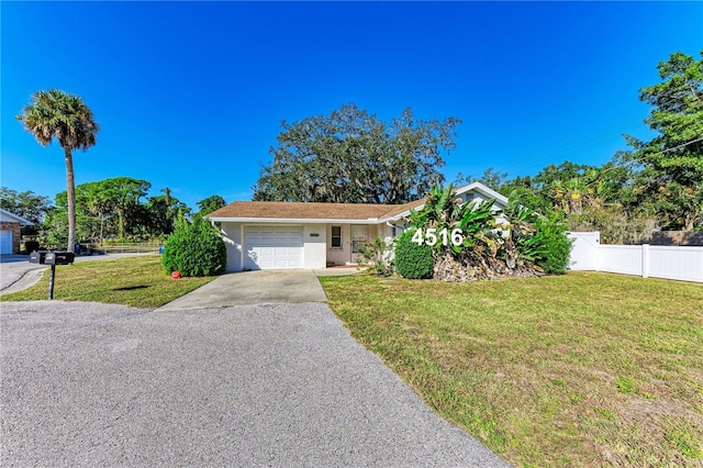 view of front of home featuring a front yard and a garage