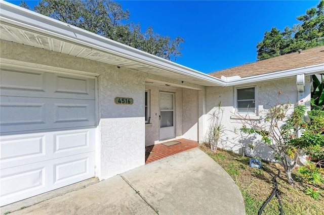 doorway to property with a garage