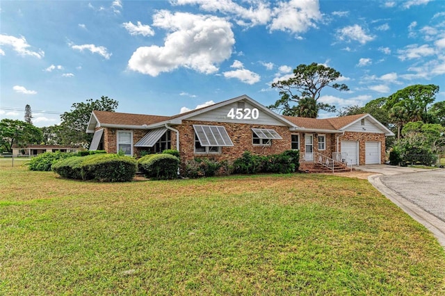 single story home featuring a front yard and a garage